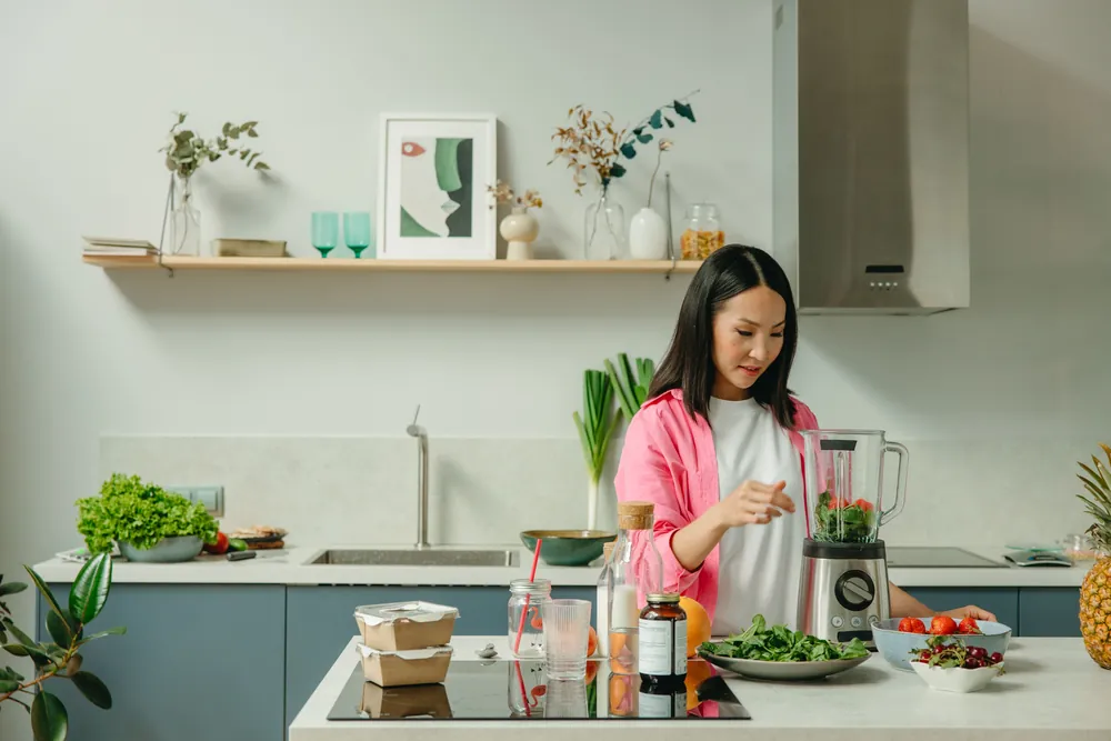 Person preparing a balanced, low-glycemic meal with fresh botanicals
